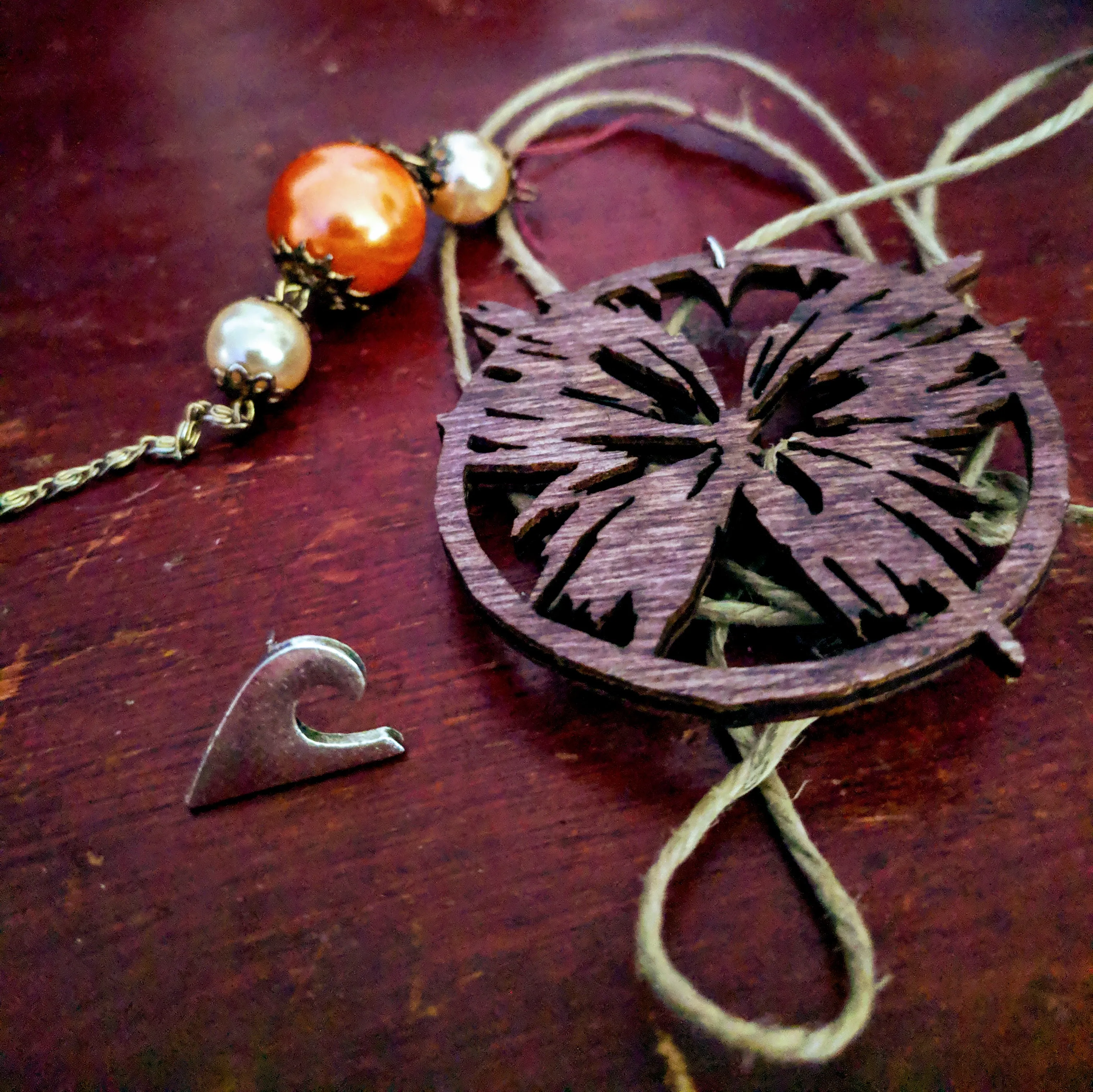 Close up of a necklace with wooden pendant