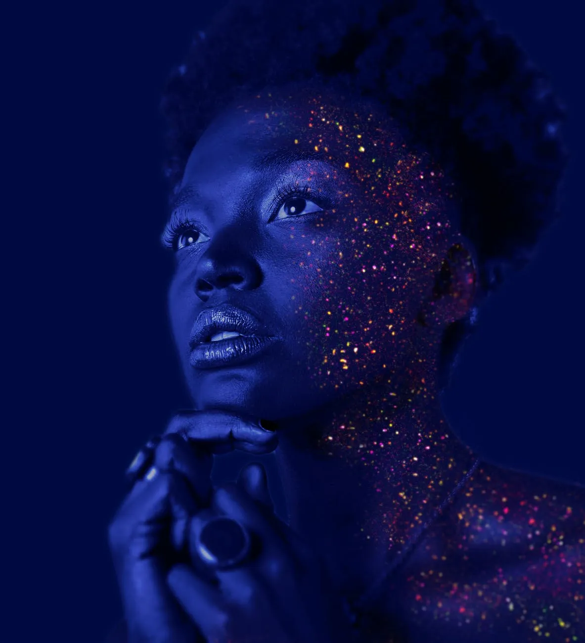 Face of a Black person with stars shining on their cheek